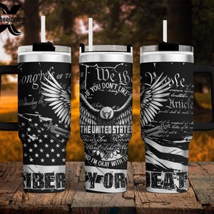 May include: Black and white insulated tumblers with handles and straws. The tumblers feature patriotic designs, including an American flag, an eagle, and text that reads "We the People" and "Liberty or Death."