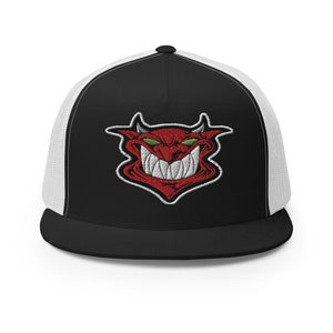 May include: Black and white trucker hat with a red devil face embroidered on the front. The devil has green eyes and a wide, toothy grin. The hat has a black brim and a white mesh back.