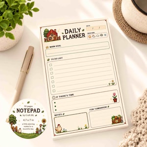 May include: A daily planner notepad featuring a cottage illustration, sections for main goal, to-do list, notes, and weather tracking. A circular sticker indicates 50 pages, 11.9 x 17.8 cm, and the text Notepad by Craft IRL, a little planning makes for a bountiful day.