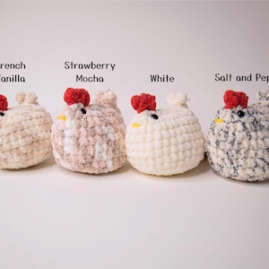 May include: Four crocheted chicken plushies in different colors: French Vanilla, Strawberry Mocha, White, and Salt and Pepper.