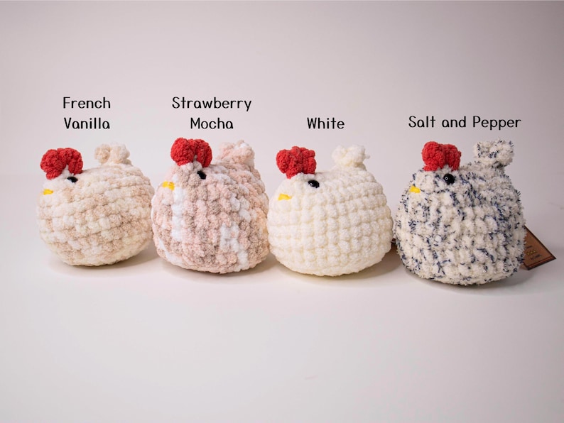May include: Four crocheted chicken plushies in different colors: French Vanilla, Strawberry Mocha, White, and Salt and Pepper.
