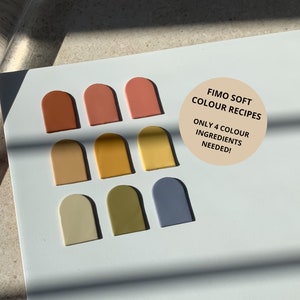 May include: A white surface displays nine arch-shaped clay samples in various colours, including terracotta, peach, and yellow. A clear rolling pin rests on the left. Text on a sticker reads "FIMO SOFT COLOUR RECIPES ONLY 4 COLOUR INGREDIENTS NEEDED!"