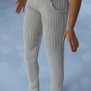 May include: A pair of light beige corduroy pants. The pants have a straight leg and a slightly flared bottom.