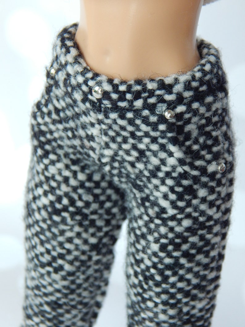 May include: Black and white checkered pants with silver studs. The pants are made of a soft, fuzzy material.