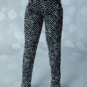 May include: Black and white patterned pants with silver buttons.