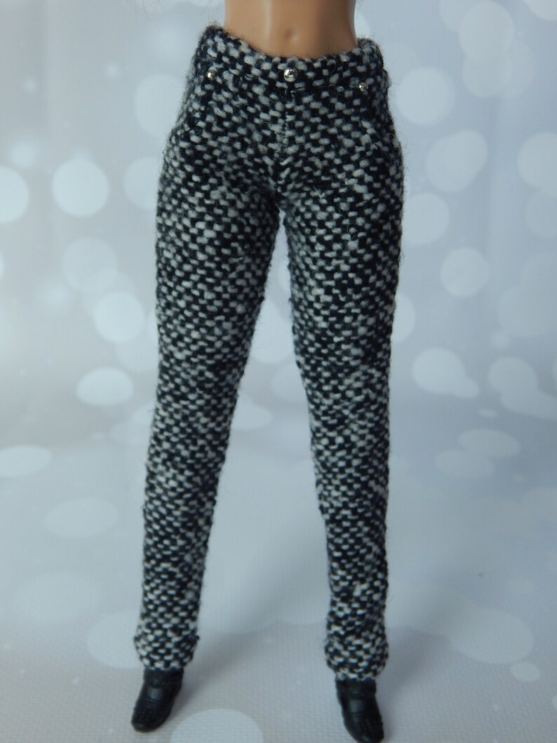 May include: Black and white patterned pants with silver buttons.