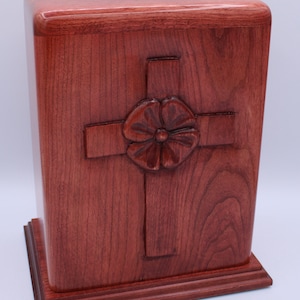 Carved poppy in cross cremation urn