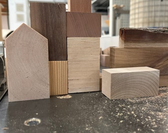Wooden building blocks in different shapes and types of wood