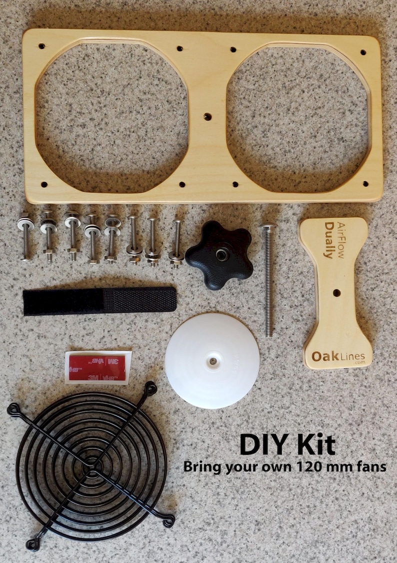 May include: DIY kit for 120 mm fans. Includes a light wood frame with two circular openings, screws, a black fan guard, a white disc, a black knob, and a velcro strap. The text "AirFlow Dually" and "OakLines" are visible.
