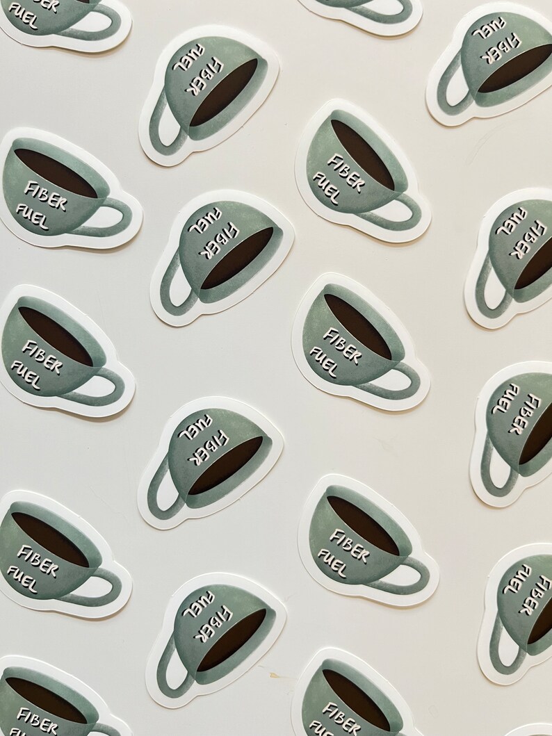 May include: Multiple stickers featuring a cartoon coffee cup with the text "Fiber Fuel" in a white font on a green background. The stickers are arranged in a grid pattern on a white surface.