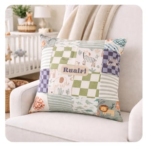 May include: A patchwork pillow with various fabric patterns, including green checkered squares, stripes, and animal prints. The name "Ruairi" is embroidered on a rectangular patch. The pillow is on a white armchair.