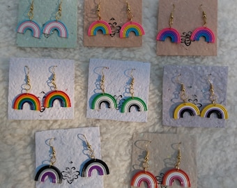 May include: Set of 10 rainbow-colored earrings with gold hooks. Each earring is a half-circle shape with different colored stripes. The earrings are displayed on small cards with a white background.