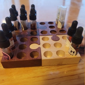 Shaker and spoon interlocking puzzle vial holder