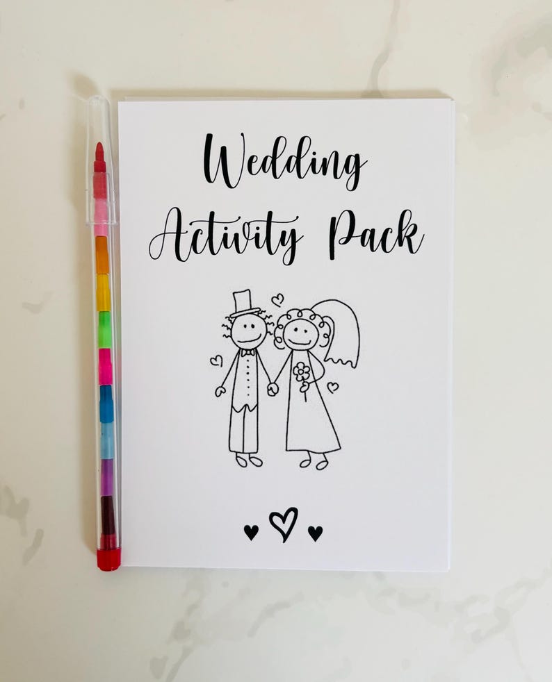 May include: A white card with the text "Wedding Activity Pack" in black lettering. A black and white illustration of a bride and groom holding hands is below the text. Three black hearts are at the bottom of the card.
