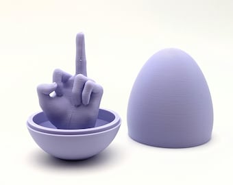 May include: A lavender-colored sculpture of a hand giving the middle finger, emerging from a matching spherical base. Beside it is a lavender egg-shaped object. The objects are set against a white background.