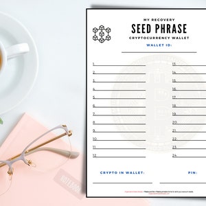 May include: A white sheet of paper with the text "MY RECOVERY SEED PHRASE CRYPTOCURRENCY WALLET" and numbered lines for writing a cryptocurrency wallet seed phrase. A cup of coffee, glasses, and a notebook are on the desk.