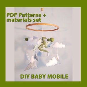 May include: DIY baby mobile kit with PDF patterns and materials. The mobile features a green felt dragon, white felt clouds, and gray felt mountains.