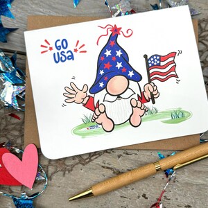 Celebrate American spirit with this delightful gnome card, displayed with the message GO USA and embellished with vibrant red starbursts. Perfect for showing your patriotism to friends during Labor Day or any special occasion!
