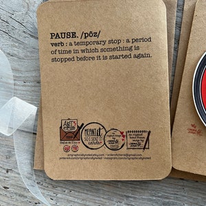 Up close of the back of the pause button card