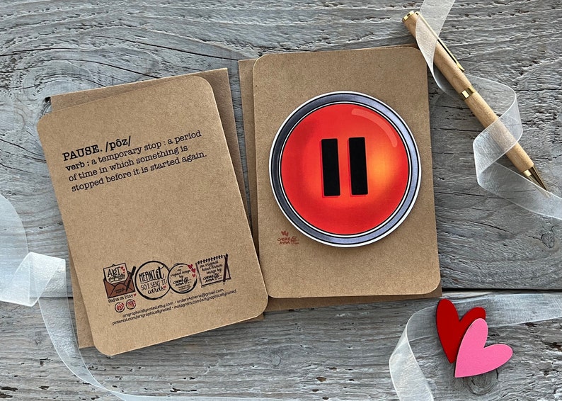 The back and front of the pause button card