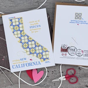 May include: A greeting card with a California outline design made of blue and yellow squares, with the text "sending sew much love from California." A red heart, scissors, and a needle are also visible.