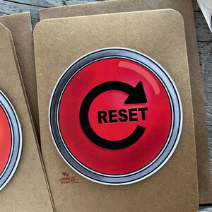 Up close of the front of the reset button card