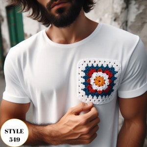 May include: White t-shirt with a square, multi-colored crochet pocket. The pocket features a floral design with red, blue, yellow, and white yarn. The text "STYLE 549" is in a gold circle in the lower left corner.