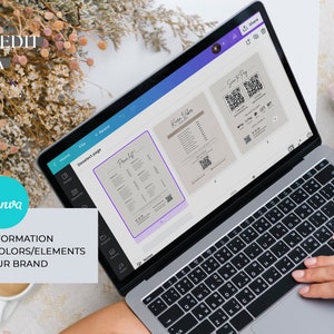 May include: A laptop computer displaying the Canva website with a design for a menu. The menu design includes a QR code and the text "Pretty Lit" and "K-Love Vibes". The laptop is on a white surface with a cup of coffee and a bouquet of dried flowers.