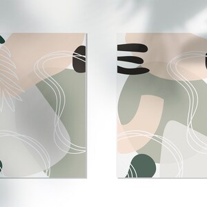 Puede incluir: Dos impresiones de arte abstracto con un esquema de color verde, blanco y rosa. Las impresiones presentan formas y l&iacute;neas org&aacute;nicas.
