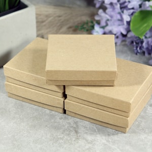 May include: A stack of six brown cardboard boxes, each with a slightly different shade of brown. The boxes are arranged in a pyramid shape, with the largest box at the bottom and the smallest box at the top.
