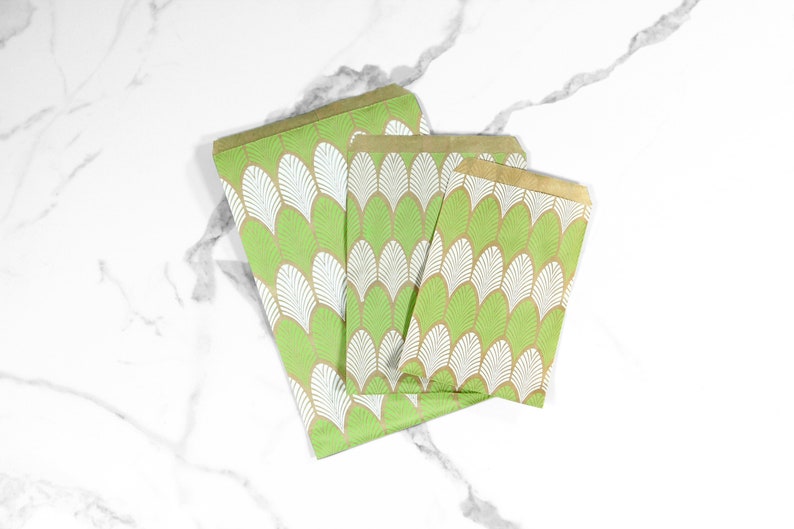 May include: Three green and white patterned paper gift bags with gold trim. The bags are arranged in a stack, with the largest bag at the bottom and the smallest bag at the top.