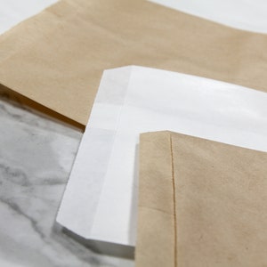 Kraft paper bags comes in two colors plain white or brown. Great for packaging, merchandise bags and even for treats
