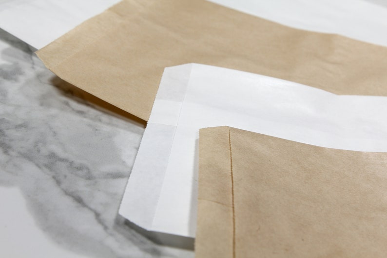 Kraft paper bags comes in two colors plain white or brown. Great for packaging, merchandise bags and even for treats
