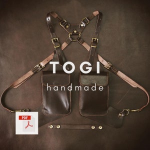 May include: Brown leather chest rig with two large pockets and adjustable straps. The rig has the text "TOGI handmade" printed on it.