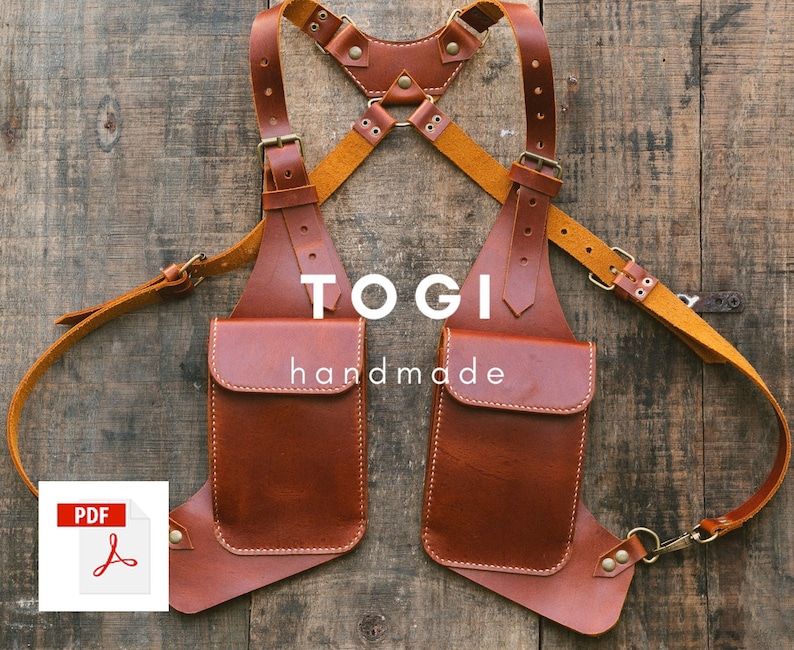 May include: Brown leather chest rig with two pockets and adjustable straps. The rig is labeled "TOGI handmade".