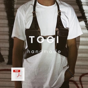 May include: A brown leather chest harness with two pockets and the text "TOGI handmade" on the front.