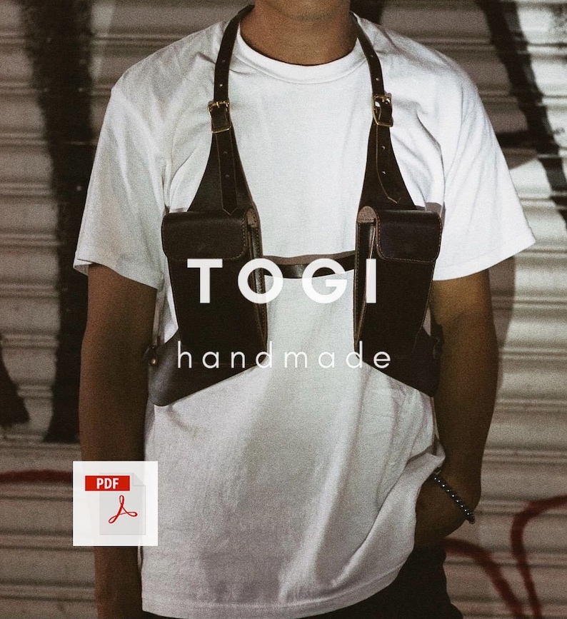 May include: A brown leather chest harness with two pockets and the text "TOGI handmade" on the front.