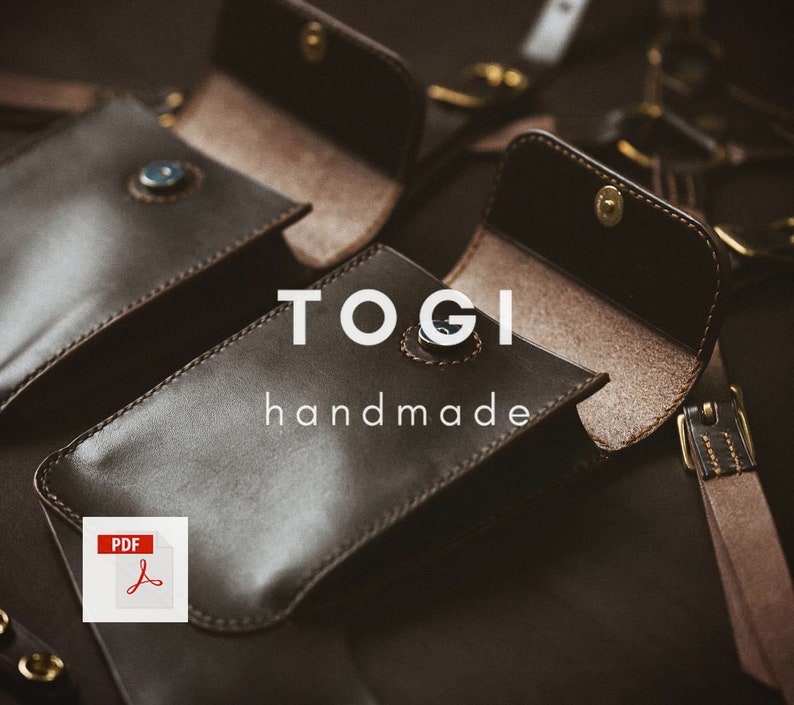 May include: Two brown leather phone cases with a brown leather strap. The cases are open and the inside is lined with a light brown fabric. The text "TOGI handmade" is printed on the front of the cases.