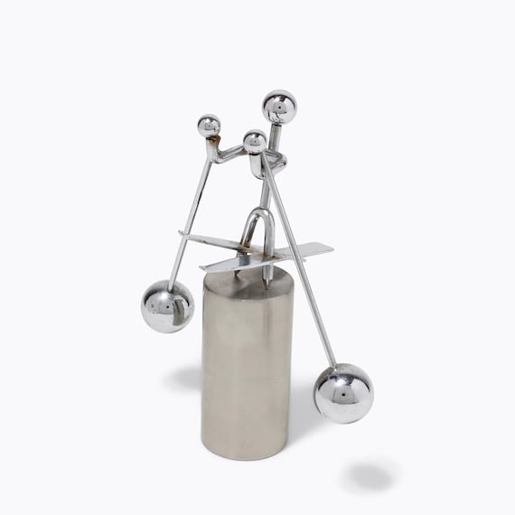 A chrome retro skier that rocks back and forth on your desk — tiny, tactile, and has serious mid-century conversation-starter energy.