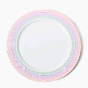 May include: A white ceramic plate with a pastel rainbow striped border. The plate's rim features bands of pink, orange, green, and purple. The plate is round and has a simple, clean design, suitable for serving food.