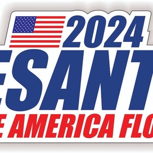 May include: A white sticker with the text "2024 DESANTIS MAKE AMERICA FLORIDA" in blue and red. An American flag graphic is at the top. The sticker has a white border.