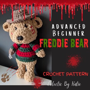 May include: A crocheted teddy bear wearing a brown hat and a red and green striped sweater. The bear has a black nose and stitched details. Text on the image reads "ADVANCED BEGINNER FREDDIE BEAR CROCHET PATTERN".