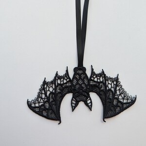 May include: Black lace bat ornament with a black ribbon for hanging.
