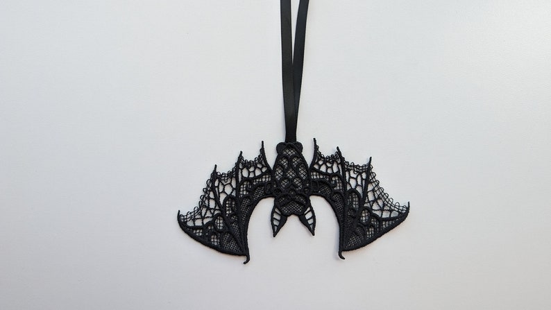 May include: Black lace bat ornament with a black ribbon for hanging.