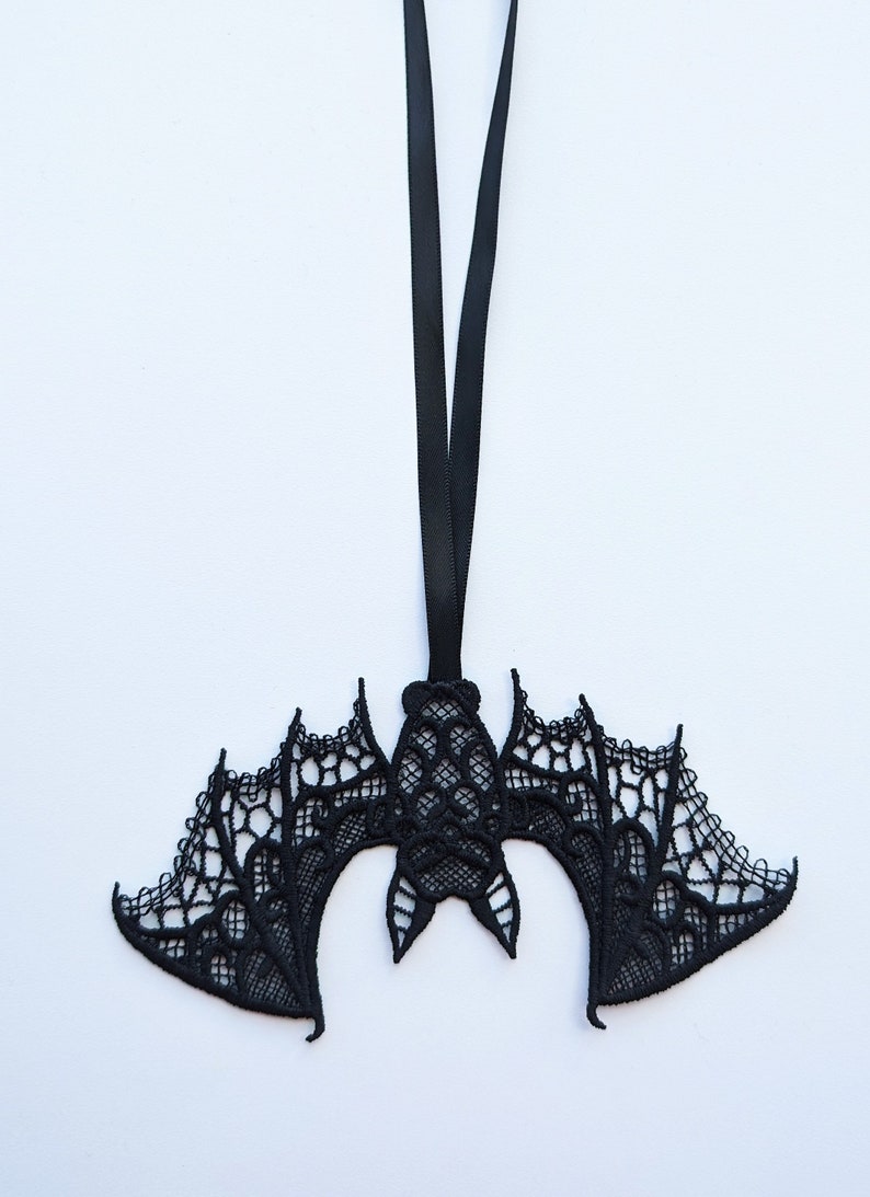 May include: Black lace bat ornament with a black ribbon for hanging.