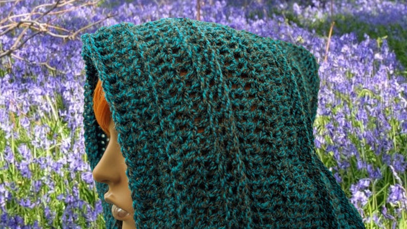 May include: A teal and brown crocheted hooded scarf with a lacy pattern.