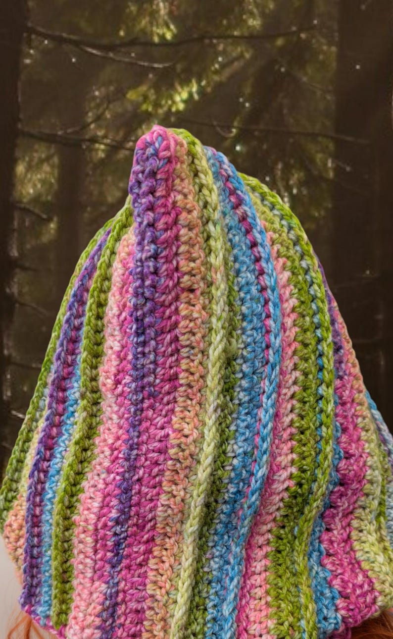 May include: A colourful striped crochet hat with a pointed top. The hat is made with a variety of shades of pink, green, blue, and white yarn.