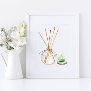 May include: Watercolor painting of a clear glass diffuser with wooden reeds and a green apple candle on a wooden base. The artwork is framed in a white frame and set against a white background. A white pitcher with white flowers is to the left.