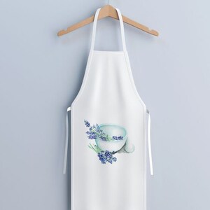 May include: White apron with a watercolor design of a light blue bowl and sprigs of lavender. The apron is hanging on a wooden hanger against a light blue wall. The apron has white straps.