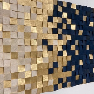 May include: A wall art piece made of wood squares in shades of gold and navy blue. The squares are arranged in a pattern that creates a gradient effect, transitioning from gold to navy blue.